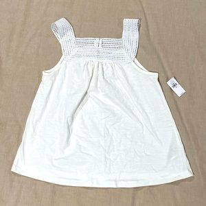 Flowy white top with crochet detail.